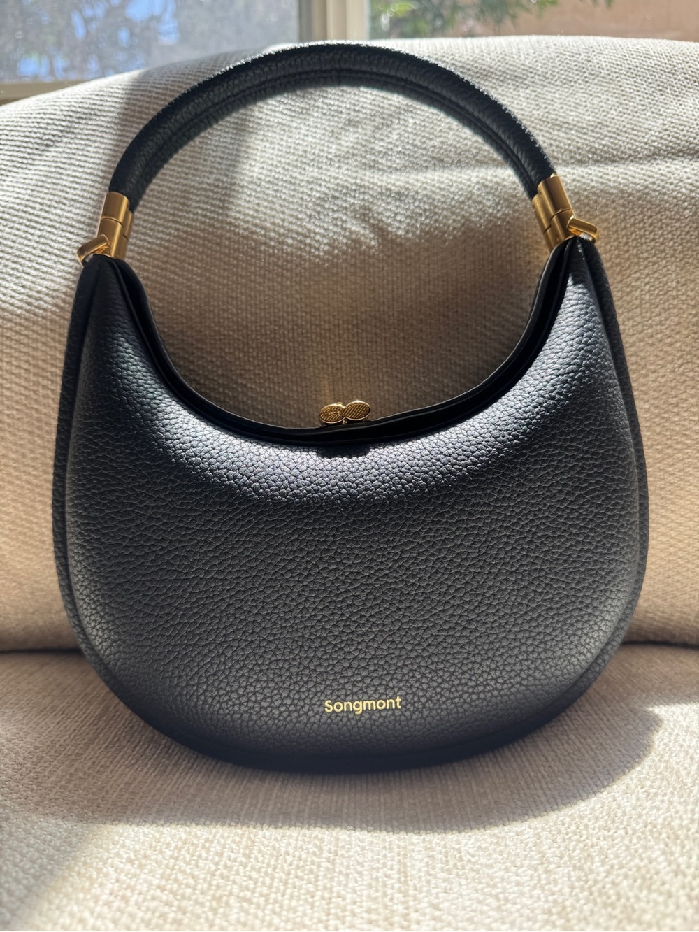 Songmont Black Crescent Shoulder Bag with Gold Accents
